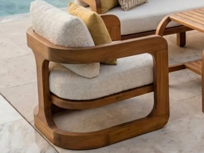 Curved solid iroko armrest of the Atlas armchair